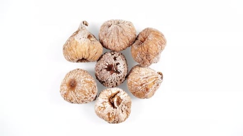 Dried Fig Fruits Rotating On White, Top View