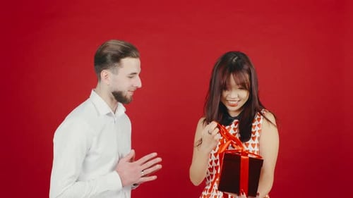 Man Gifts Woman a Birthday Present