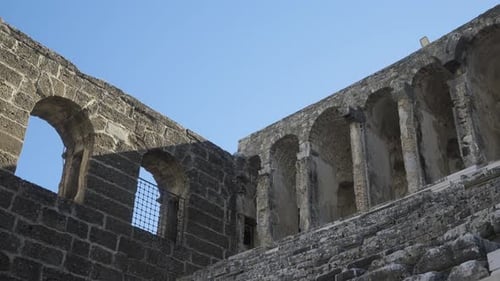 The Camera Moves Along the Steps of the Seats of the Ancient Amphitheater