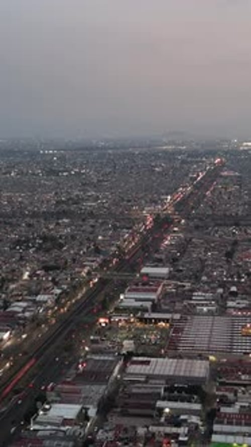 Traffic congestion on an avenue in Ecatepec as dusk descends, vertical drone view