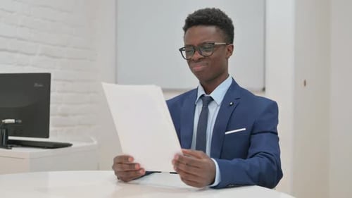 Young Adult Reacting to Bad News at Office