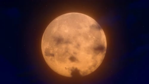 Clouds Drifting Across a Full Moon in the Night Sky