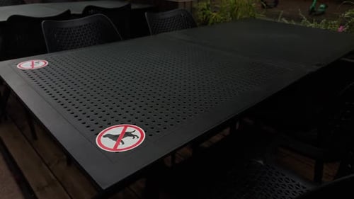 An Outdoor Table Featuring No Smoking Signs Clearly Displayed in a Restaurant for Health and Safety