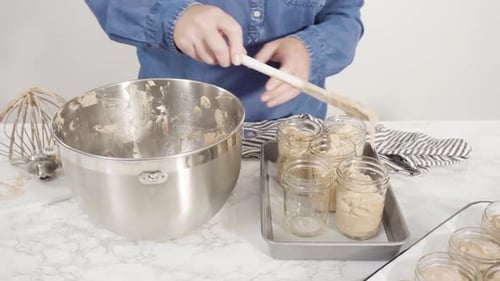 Step By Step Scooping Homemade Chocolate Ice Cream Into Glass Jars