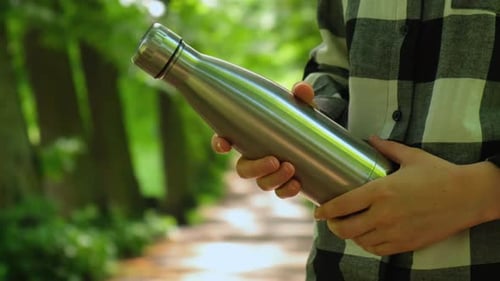 Closeup of Unrecognizable Female Hand Holding Water Bottle