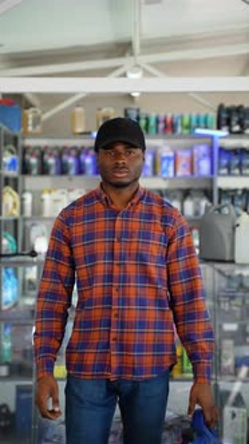 Young Adult Man with a Blue Oil Container