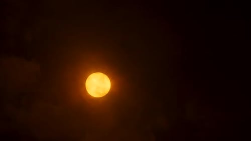 Clouds moving in front of the sun on a cloudy day