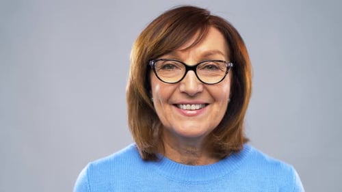 Smiling Woman in Blue Sweater and Glasses Portrait