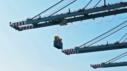 Shipping Container Suspended from Large Crane