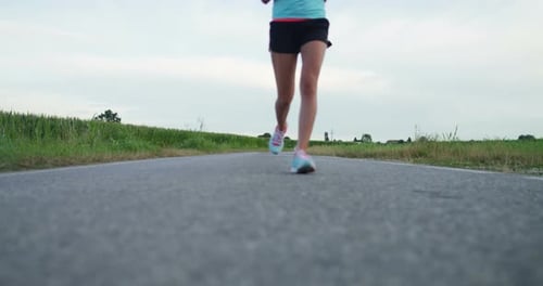 Woman Running on Rural Asphalt Road