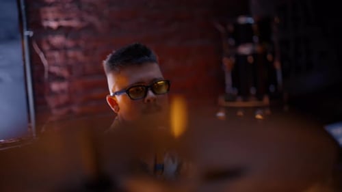 Young Drummer Making Beat with Rock Band at Dark Nightclub Stage Closeup