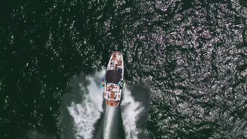 Speed boat with people roaring across the Sea at high speed