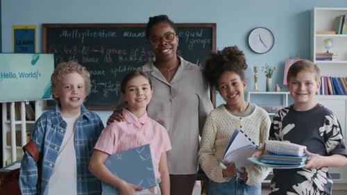 Teacher and Students Smiling Together in Classroom
