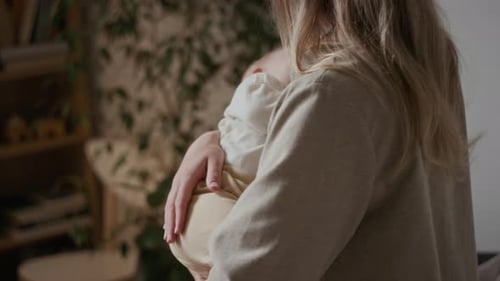 Mother Comforting Infant at Home