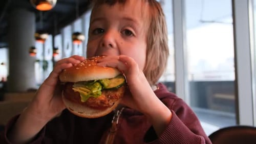 Child Eating Burger Close Up