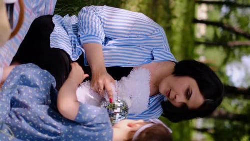 Mother and child together in the park outdoors, lying in the grass. Motherhood happiness concept. Da