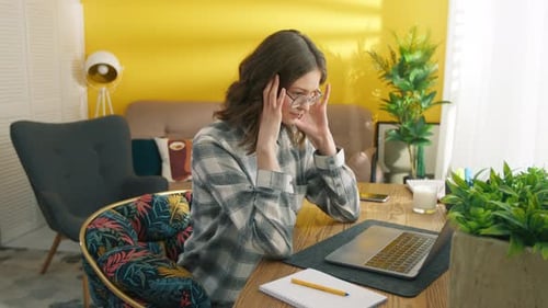 Young Woman Working from Home on Laptop
