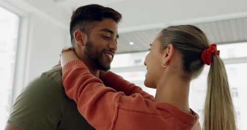 Loving Couple Embraces Affectionately Indoors by Window