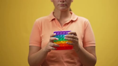 Woman Holding Rainbow Pop It Fidget Toy