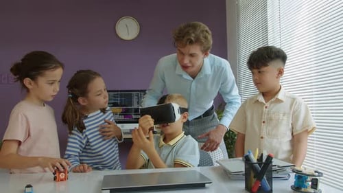 Kids Using VR Headset With Teacher Supervision