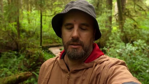 Content creator recording a video in the rainforest of vancouver island