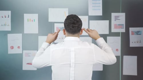 Excited Young Man Celebrates Success in Modern Office