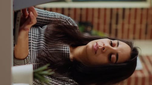 Smiling Woman Working on Laptop at Home