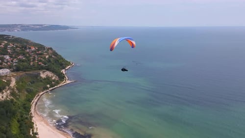 A Paraglider Soars Over the Sea and Forest with a Breathtaking View of the Resort Town of Albena in
