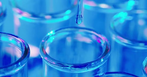 Clear Liquid Dropping into Test Tube Close Up