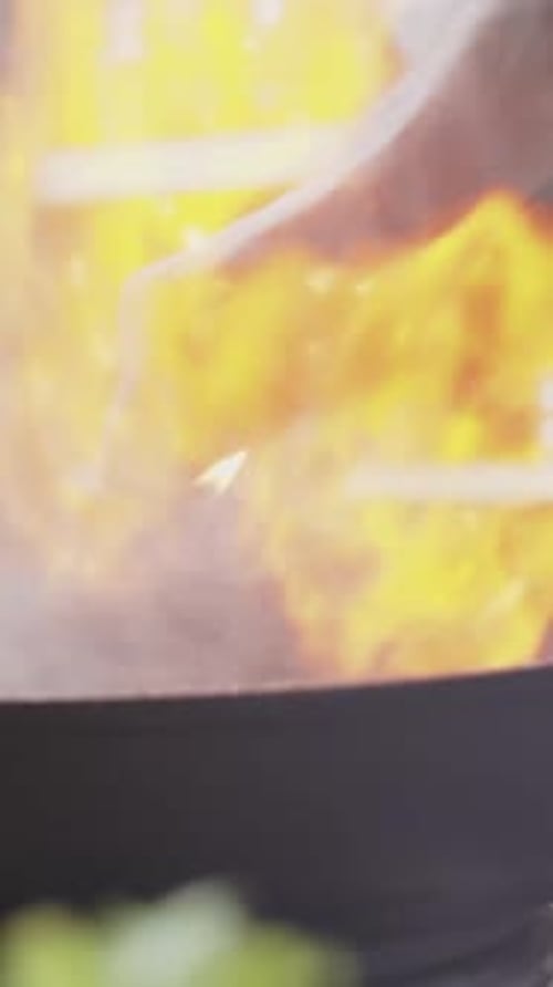 Close-up of Unrecognizable Chef Adding Cognac to Skillet