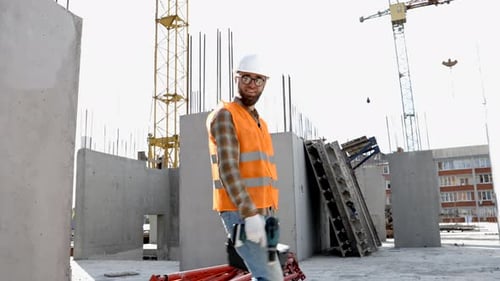 Construction Worker Walking at Sunny Construction Site