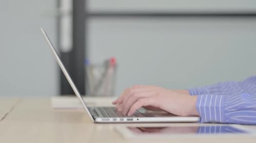 Side View of Businesswoman Working on Laptop
