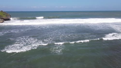 Aerial view of giant ocean waves crashing and foaming