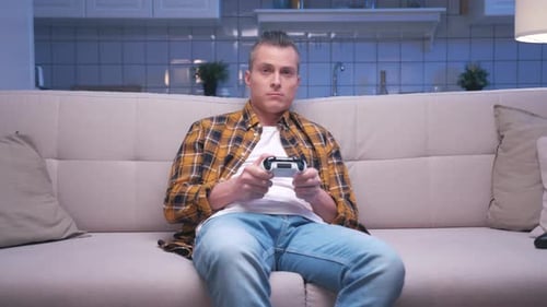 Man Relaxing at Home Playing Video Game