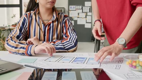 Unrecognizable Mobile App Designers Discussing Wireframe Mockup Ideas