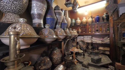 footage of display selling handmade wood, pottery and metal carving crafts from Morocco