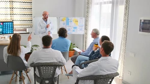 Medical Professionals Meeting with Doctor Giving Presentation
