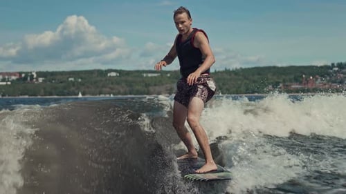 The Man is Engaged in Extreme Sports on the Water Wakesurf Gives you the Opportunity to Surf on the