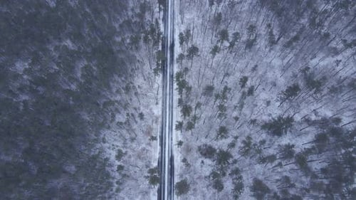 Heavy Snowfall Covering Forest And Road Landscape - aerial shot