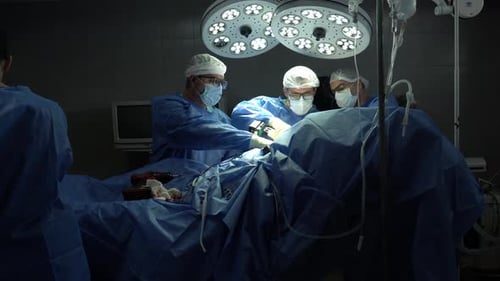 Surgeons Performing Medical Procedure in Operating Room