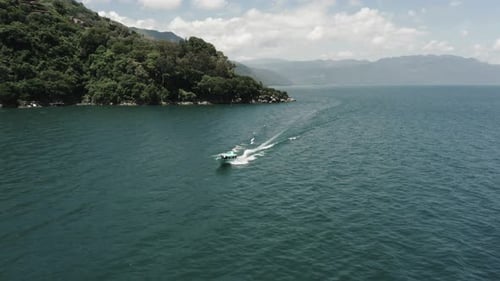 Motorboat sailing on Atitlan Lake, Guatemala. Aerial reverse