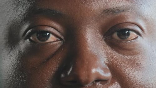 Extreme Close Up African Male Face in Detail Adult Man Model Client of Ophthalmology with Dark Skin