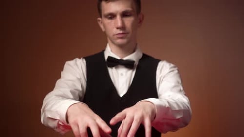 Young Caucasian Casino Dealer Puts Cards on the Red Table Closeup Hands Panorama