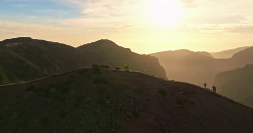 Hikers on Mountain Ridge at Sunrise