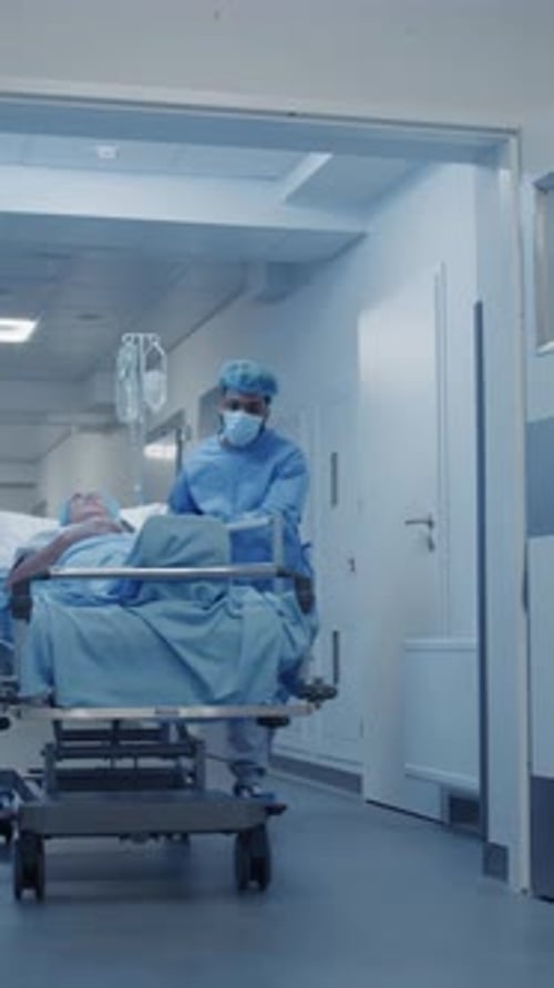 Healthcare Workers Moving Patient on Gurney