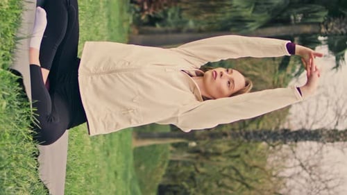 Woman Stretching Arms in Urban Park