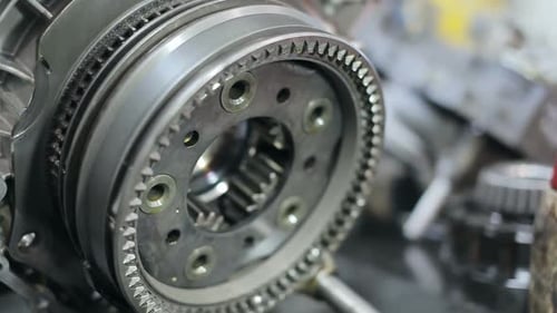 Clean steel gears of a large truck transmission close up in a repair workshop