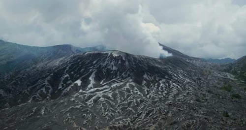 Aerial Drone View of Bromo Volcano Crater with Thick Fog and Mountain Landscape