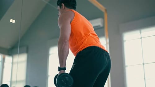 Man Lifting Weights in Gym