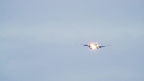 Front View Flying Jet Passenger Plane Scenic Shot Airliner Arriving in Airport and Landing at Dusk